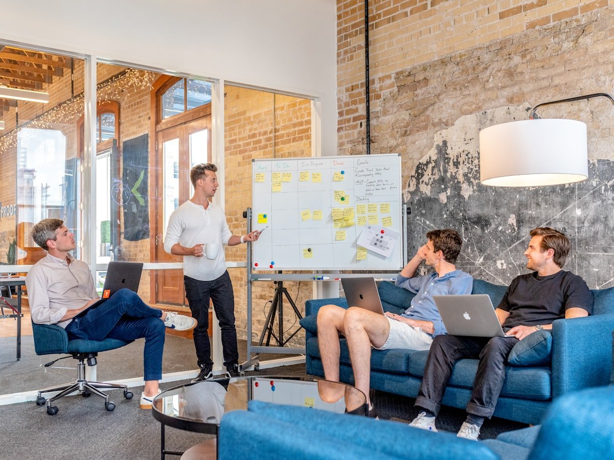 Marketing team collaborating around a whiteboard