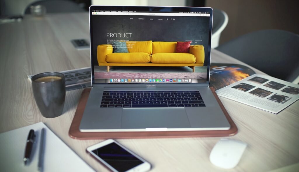 Laptop displaying a professional business website on a desk with coffee